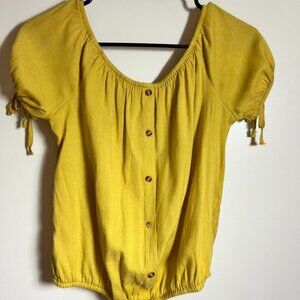 yellow blouse with decorative buttons